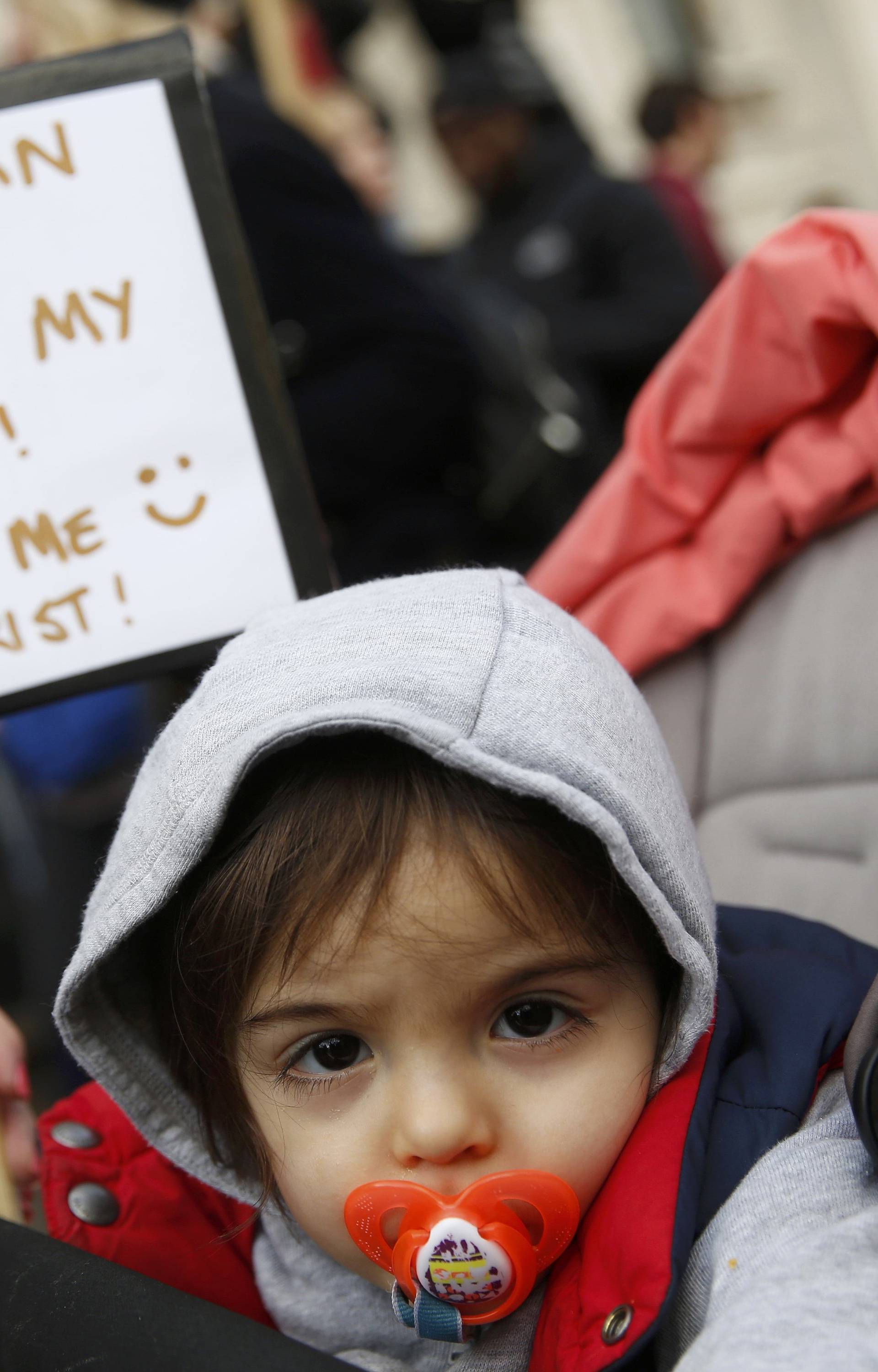 A demonstrator holds a placard during a march against U.S. President Donald Trump in London