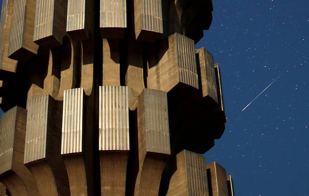 Meteor streaks across skies near the Monument to the Revolution in Prijedor