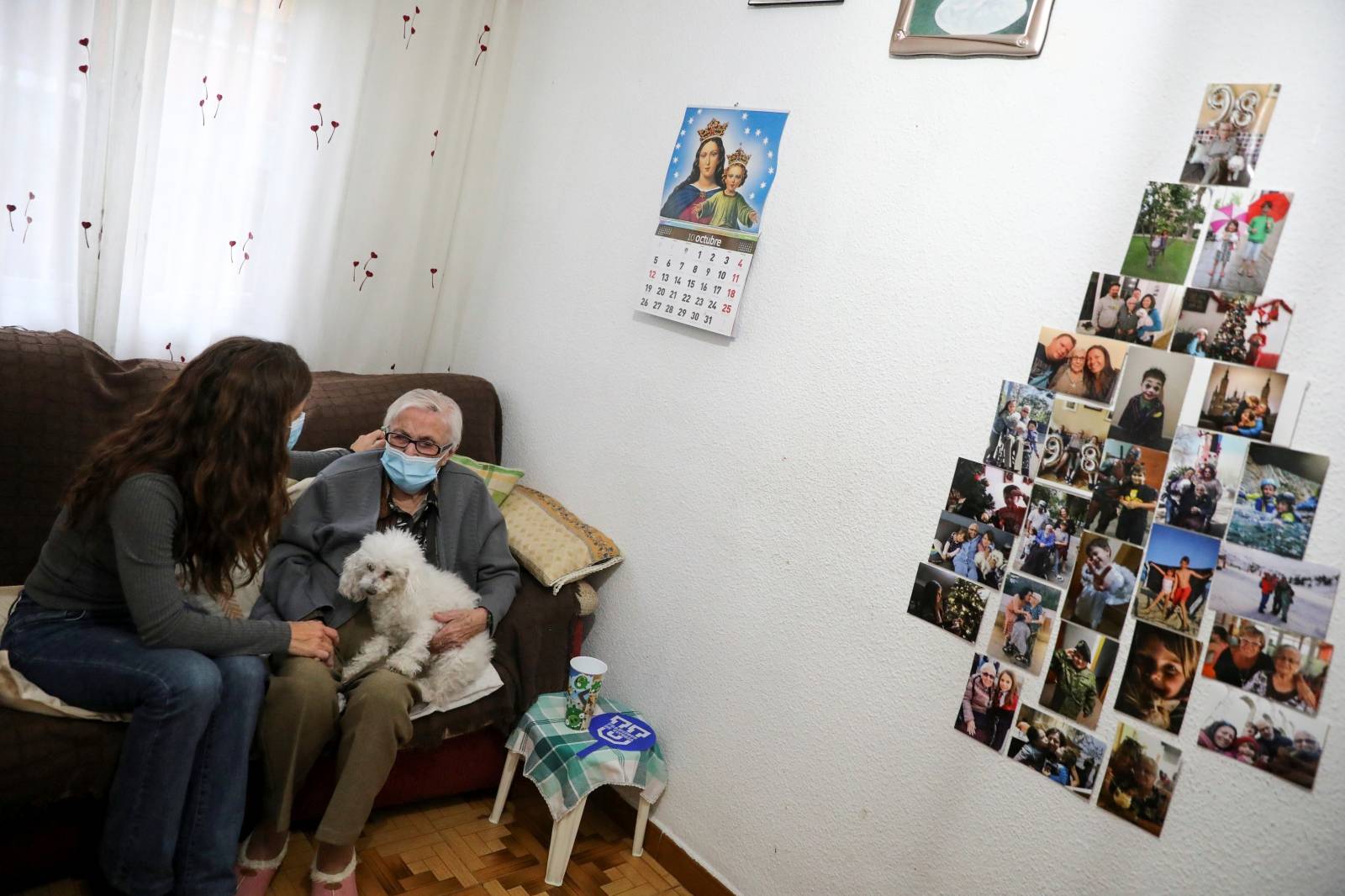 Florentina Martin, a 99 year-old woman who survived coronavirus disease (COVID-19), sits with her granddaughter Noelia Valle in her home in Pinto
