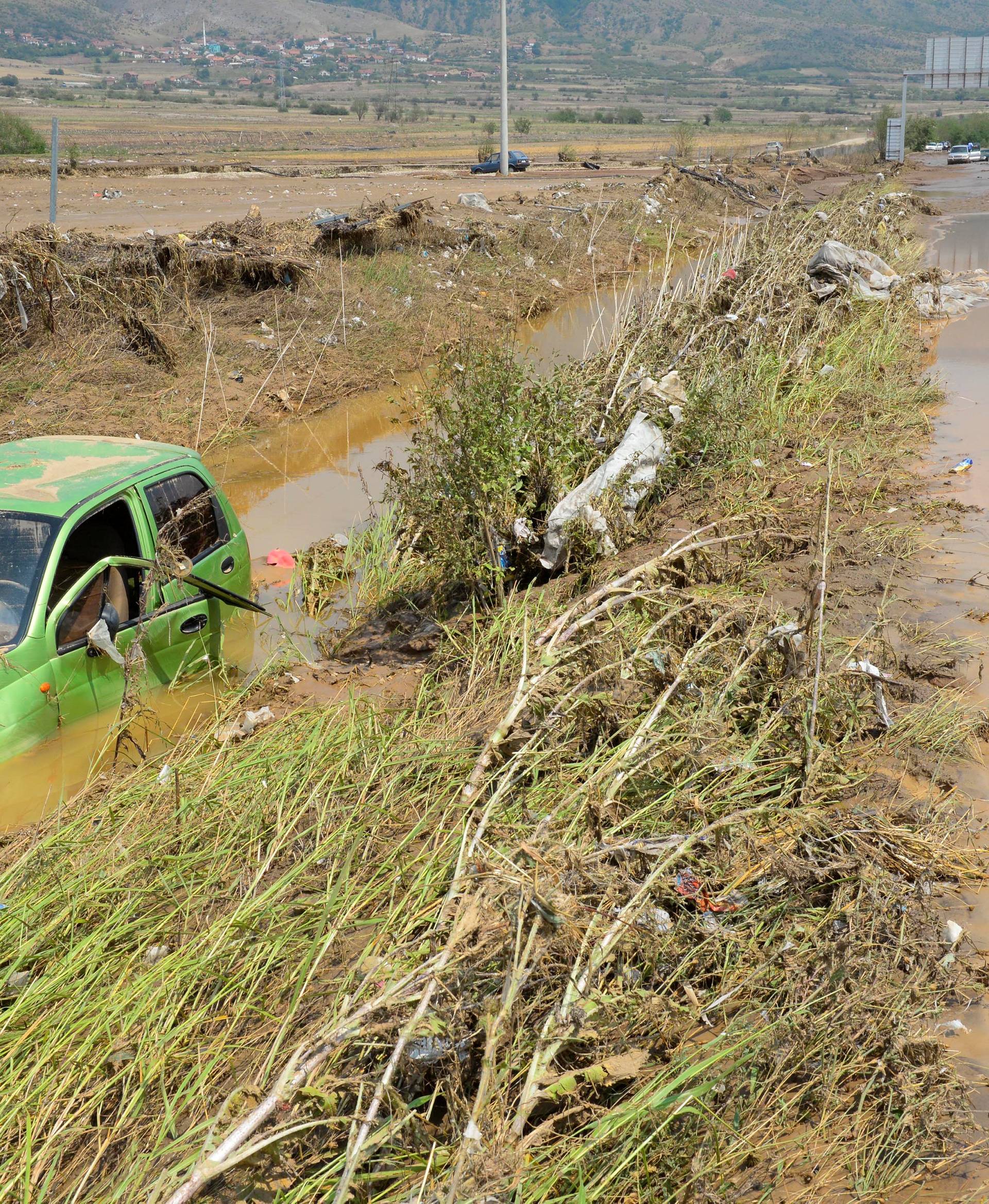 A wrecked car is seen after heavy floods in Cento 