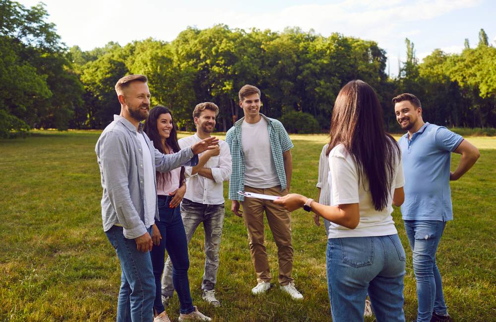 Group,Of,Happy,Friends,Or,Corporate,Coworkers,Standing,On,Grass