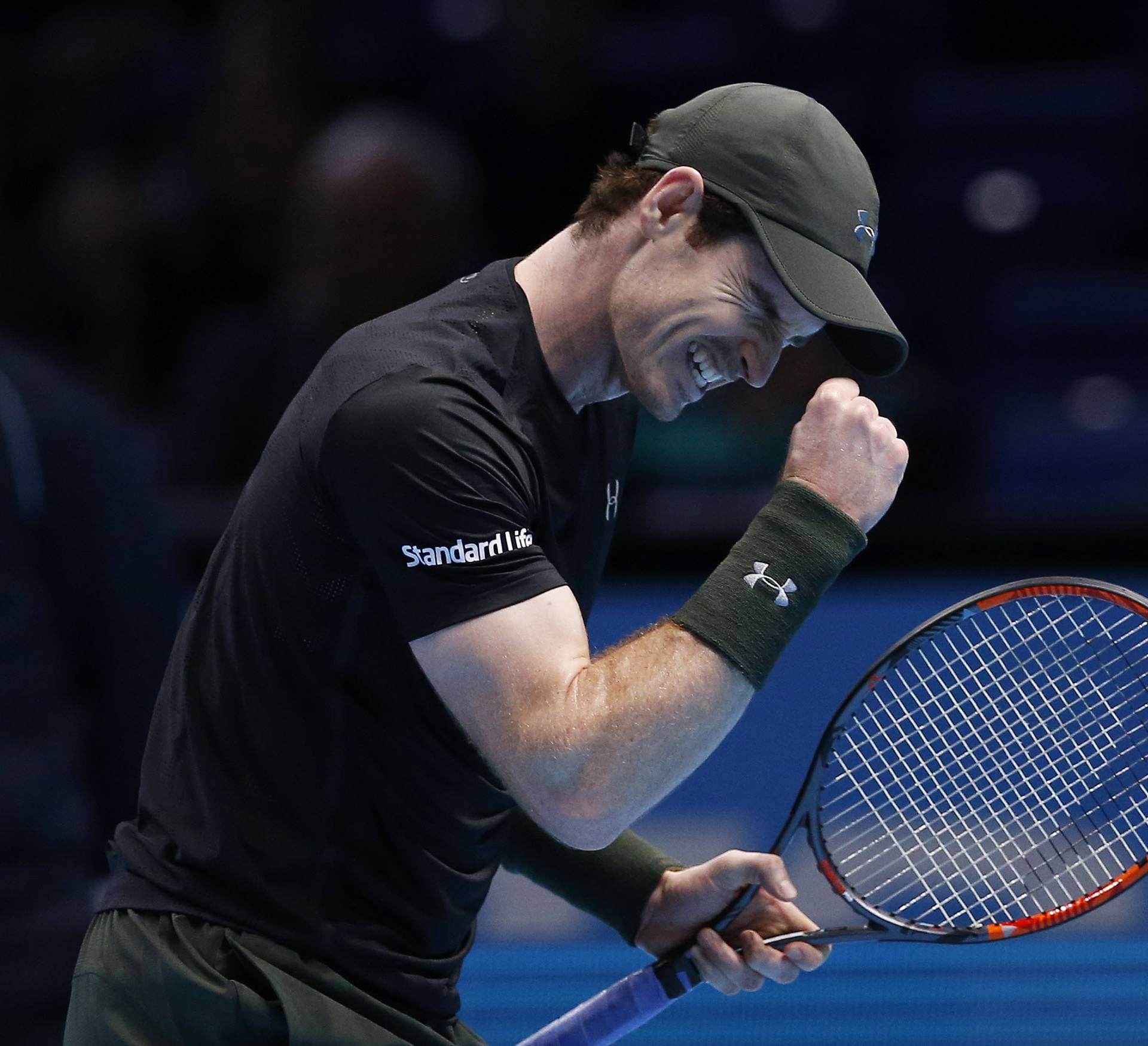 Great Britain's Andy Murray celebrates winning his round robin match against Japan's Kei Nishikori