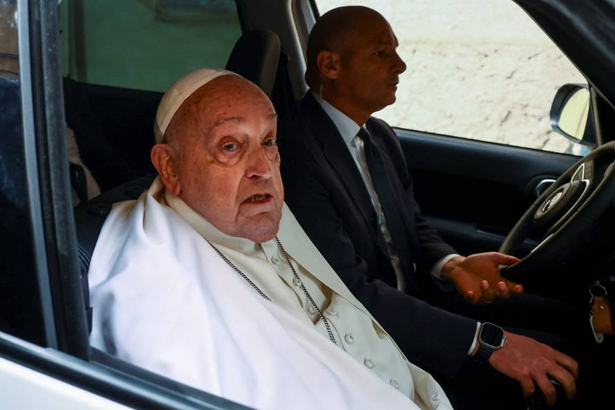 Pope Francis looks on as he leaves Regina Coeli prison after a visit, in Rome