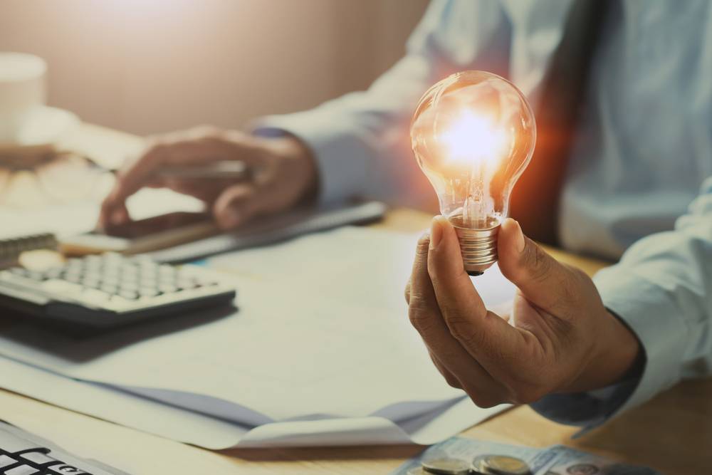 Hand,Man,Accountant,Holding,Light,Bulb,,New,Idea,With,Innovation