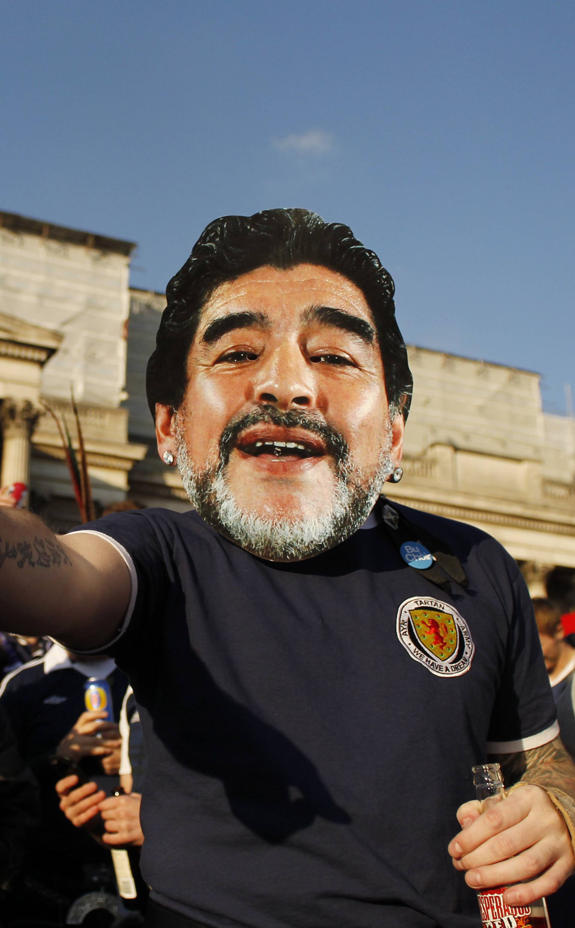 A Scotland fan wearing a face mask of Diego Maradona in Trafalgar Square