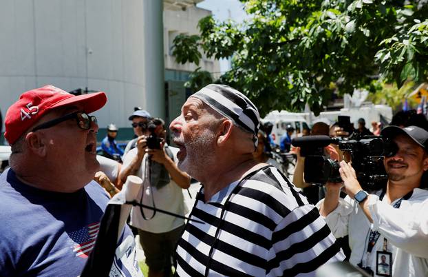 A supporter of former U.S. President Donald Trump and an anti-Trump demonstrator argue near the Wilkie D. Ferguson Jr. United States Courthouse