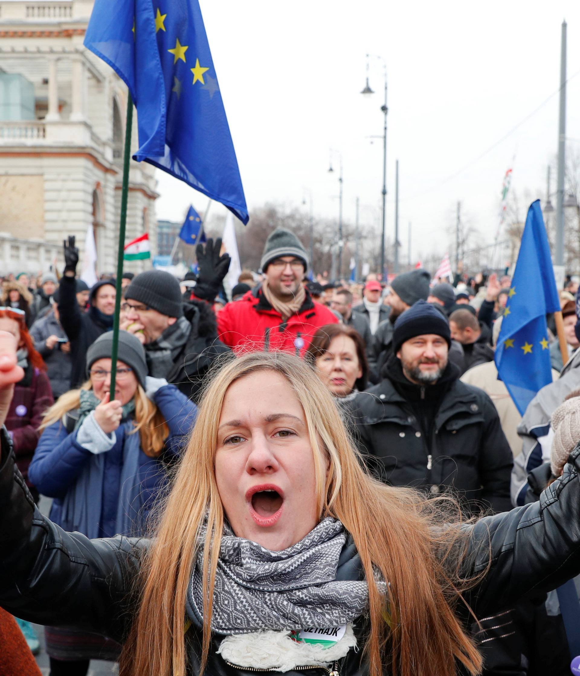 People take part in a protest against a proposed new labor law, billed as the "slave law", in Budapest