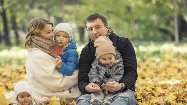 Beautiful Young Family With Children In The Autumn Park. Love An