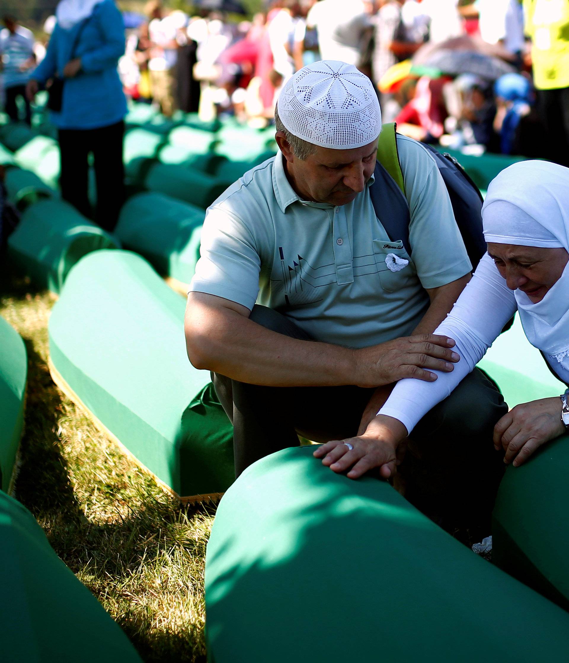 Muslim woman cries near coffins of her relatives, who are newly identified victims of the 1995 Srebrenica massacre, which are lined up for a joint burial in Potocari near Srebrenica