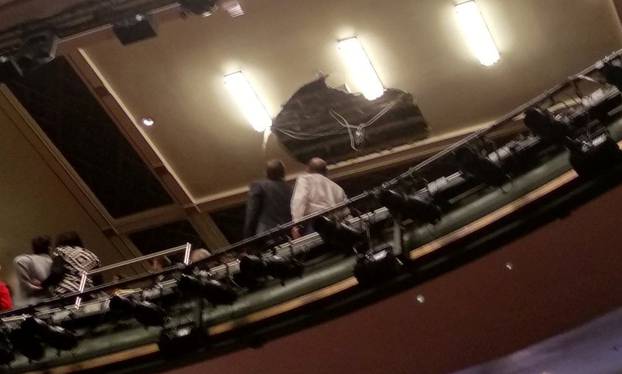People look at the collapsed roof of Piccadilly Theatre during 