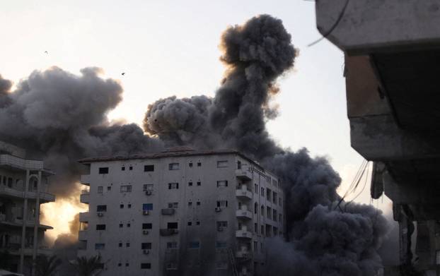 Residential building collapses after an Israeli air strike, in Gaza City
