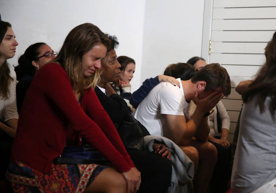 Relatives of Brazilian journalist Guilherme Marques mourn during a mass in Rio de Janeiro