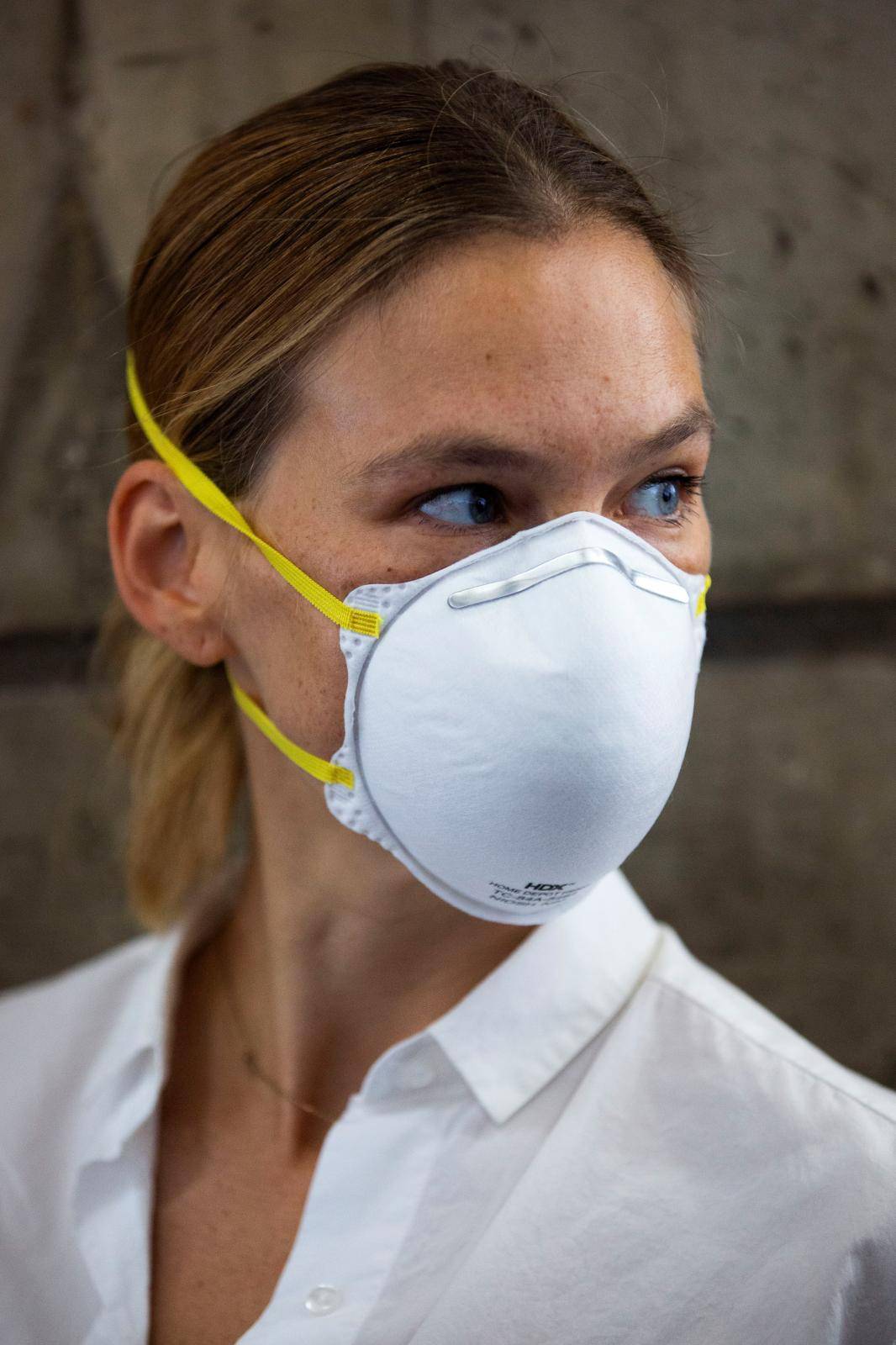 Israeli model Bar Refaeli wears a face mask as she arrives for a hearing in the tax evasion case against her and her mother Tzipi, at a court in Tel Aviv, Israel