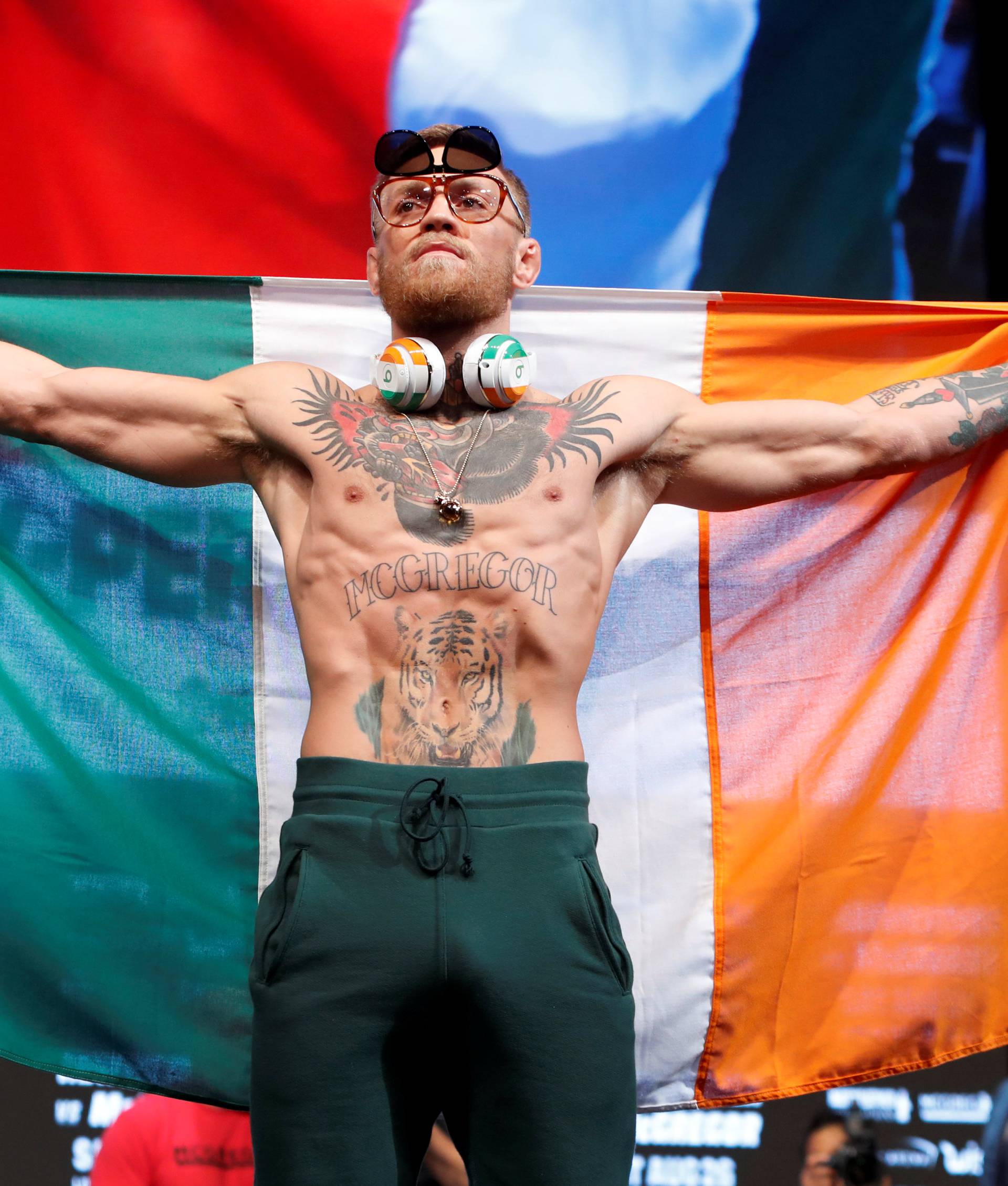 UFC lightweight champion Conor McGregor of Ireland arrives on stage for his official weigh-in at T-Mobile Arena in Las Vegas
