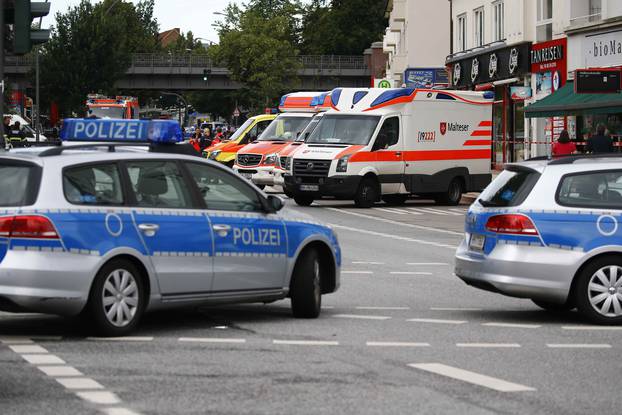 Security forces and ambulances are seen after a knife attack in a supermarket in Hamburg