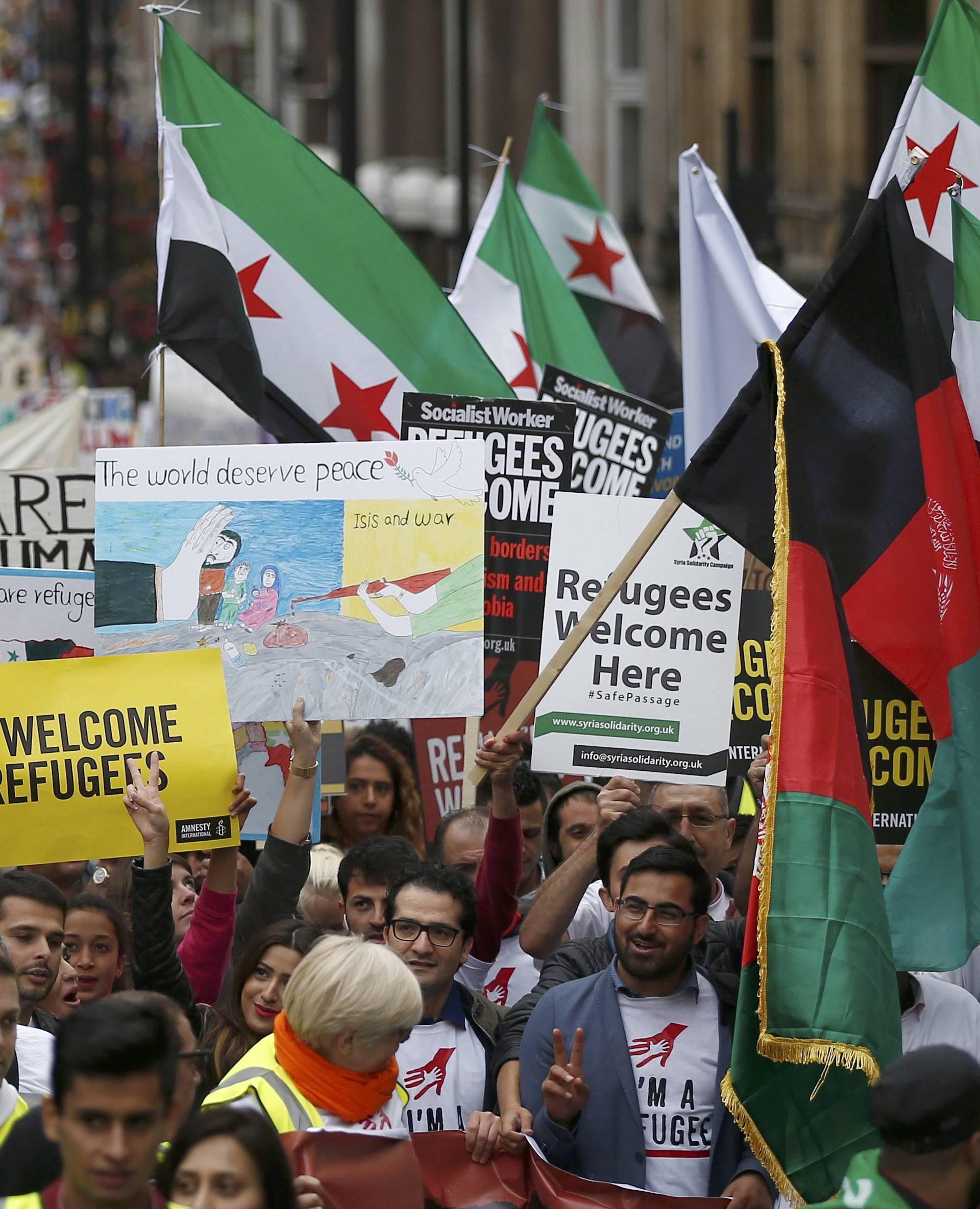 Demonstrators including refugees march to the Houses of Parliament during a protest in support of refugees, in London