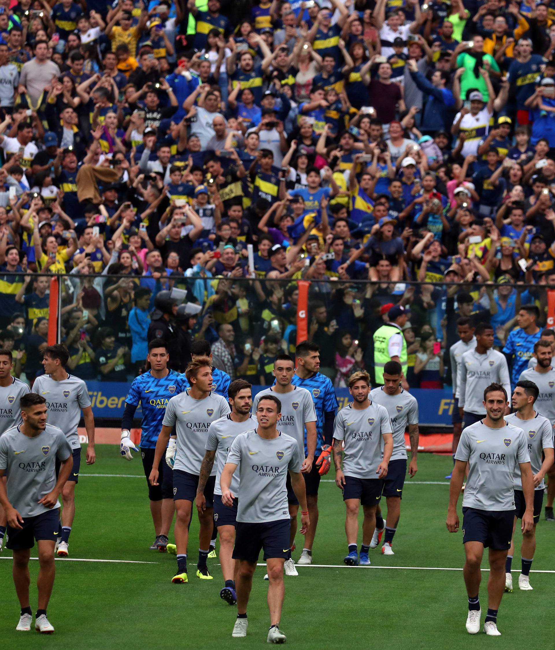 Boca Juniors' players enter the field during a training session open to the public ahead of their second leg Copa Libertadores final match against River Plate in Buenos Aires