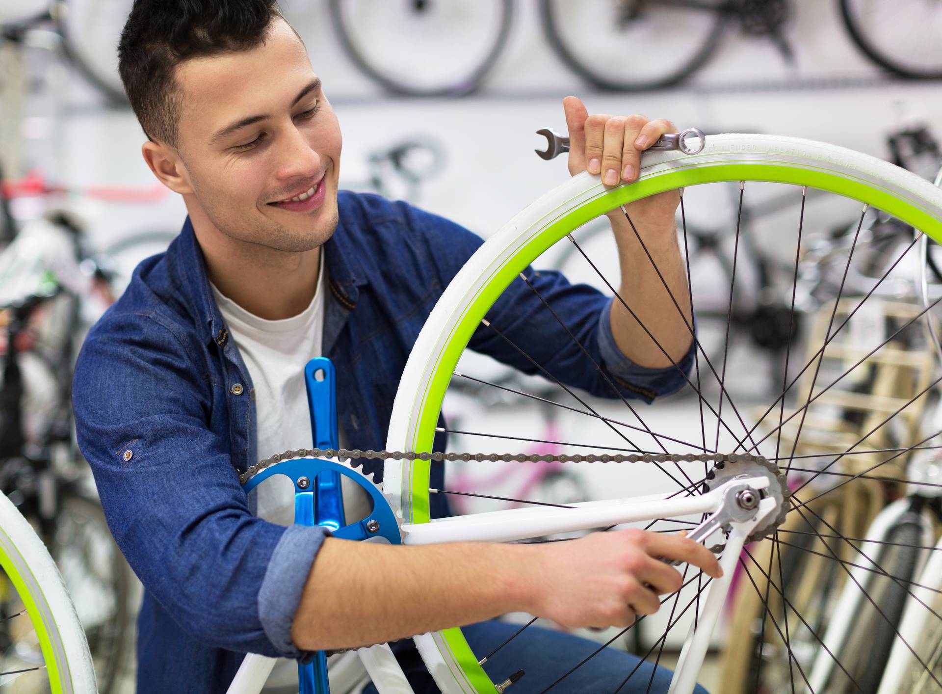 Technician fixing bicycle in repair shop