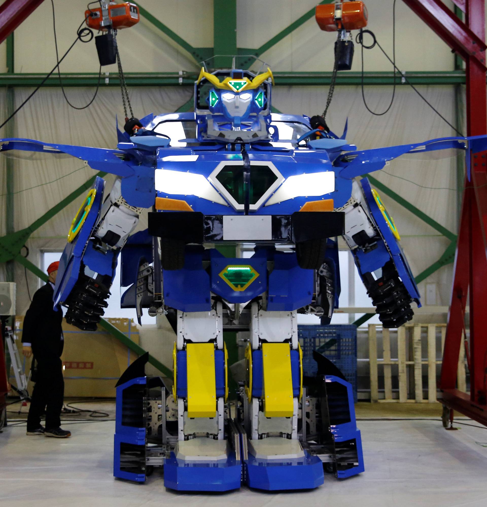 New transforming robot called "J-deite RIDE" that transforms itself into a passenger vehicle, developed by Brave Robotics Inc, Asratec Corp and Sansei Technologies Inc, demonstrates during its unveiling at a factory near Tokyo