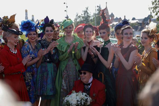 FILE PHOTO: Designer Slava Zaitsev and models pose for a picture after the show during the Moscow Fasion Week in Moscow