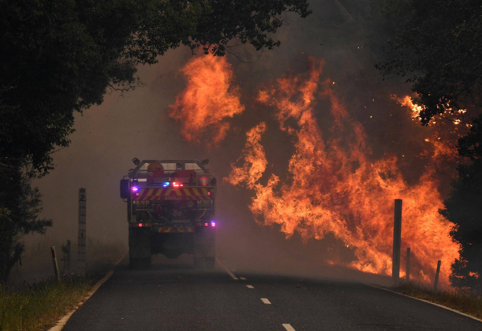 A fire truck is seen near a bushfire in Nana Glen