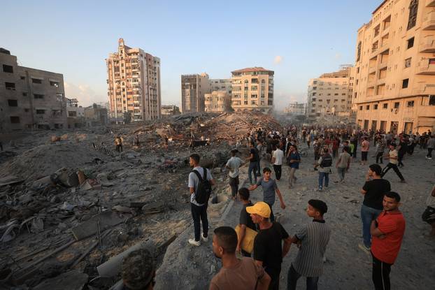 Residential building collapses after an Israeli air strike, in Gaza City