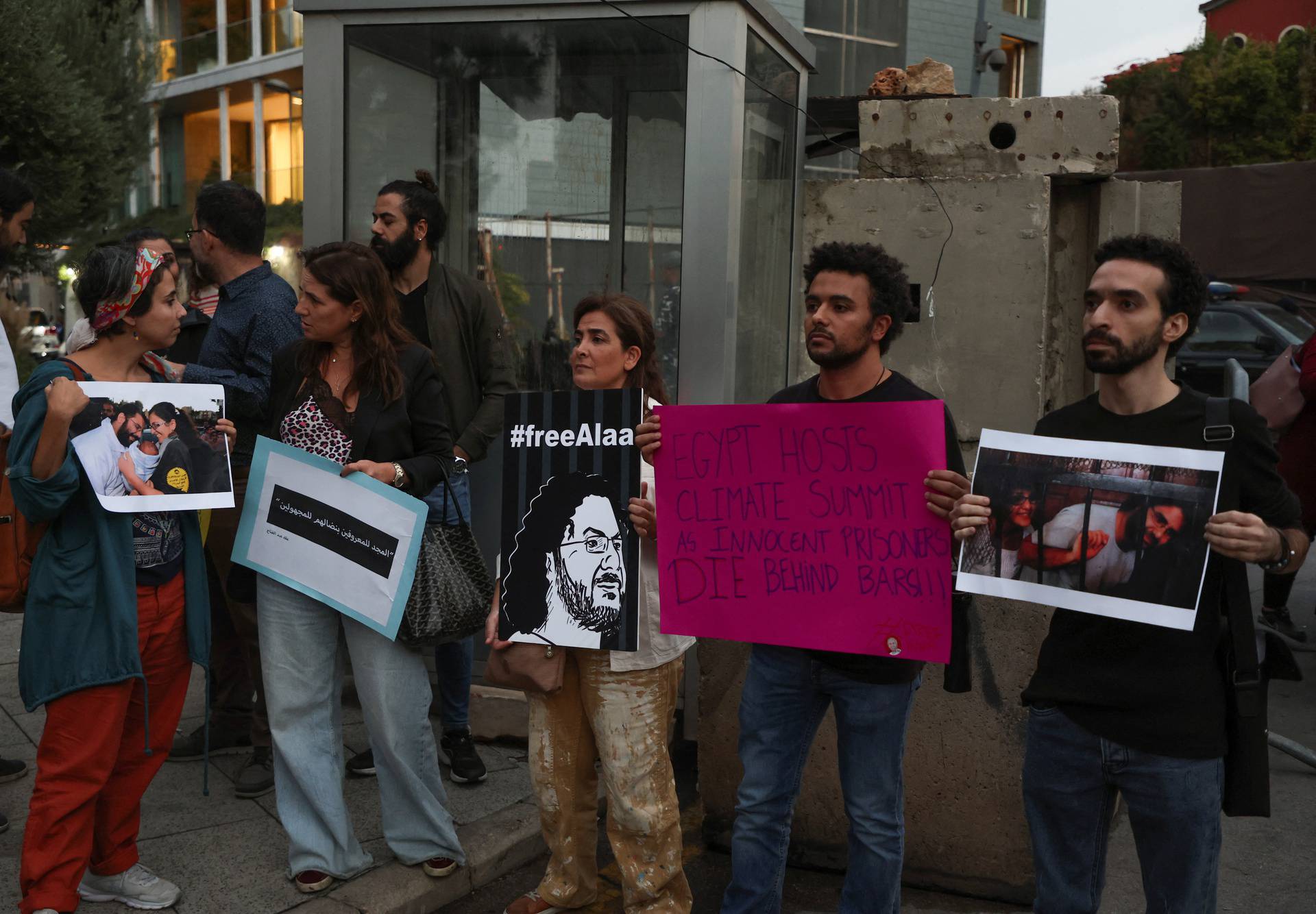 Demonstrators hold signs as they demand the release of Egyptian-British hunger striker Alaa Abd el-Fattah near the British Embassy in Beirut