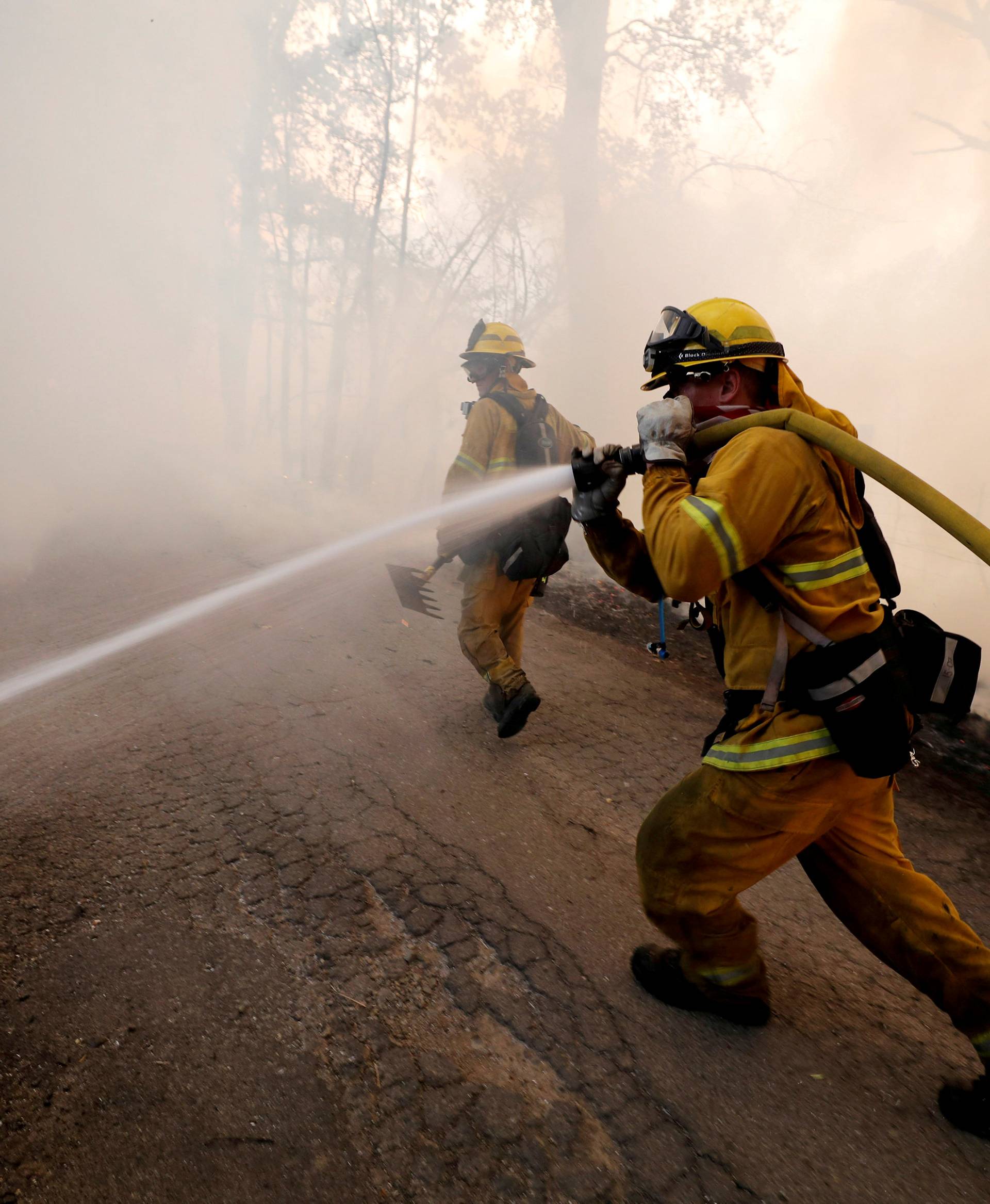 FILE PHOTO: Firefighter knocks down hotspots to slow the spread of the River Fire in Lakeport