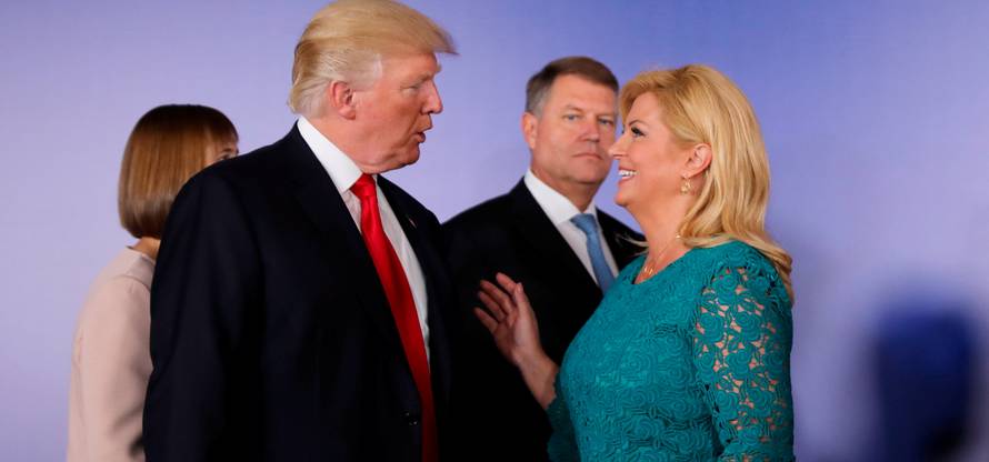 U.S. President Donald Trump talks to Croatian President Kolinda Grabar-Kitarovic during the Three Seas Initiative Summit in Warsaw