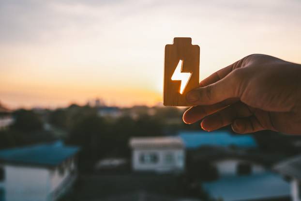 People,In,A,Common,Household,Holding,A,Symbol,Of,Electricity