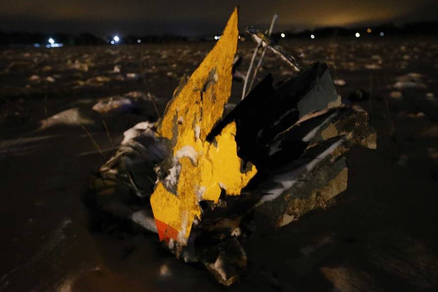 A part of a Saratov Airlines Antonov AN-148 plane that crashed after taking off from Moscow's Domodedovo airport, is seen at the scene of the incident outside Moscow