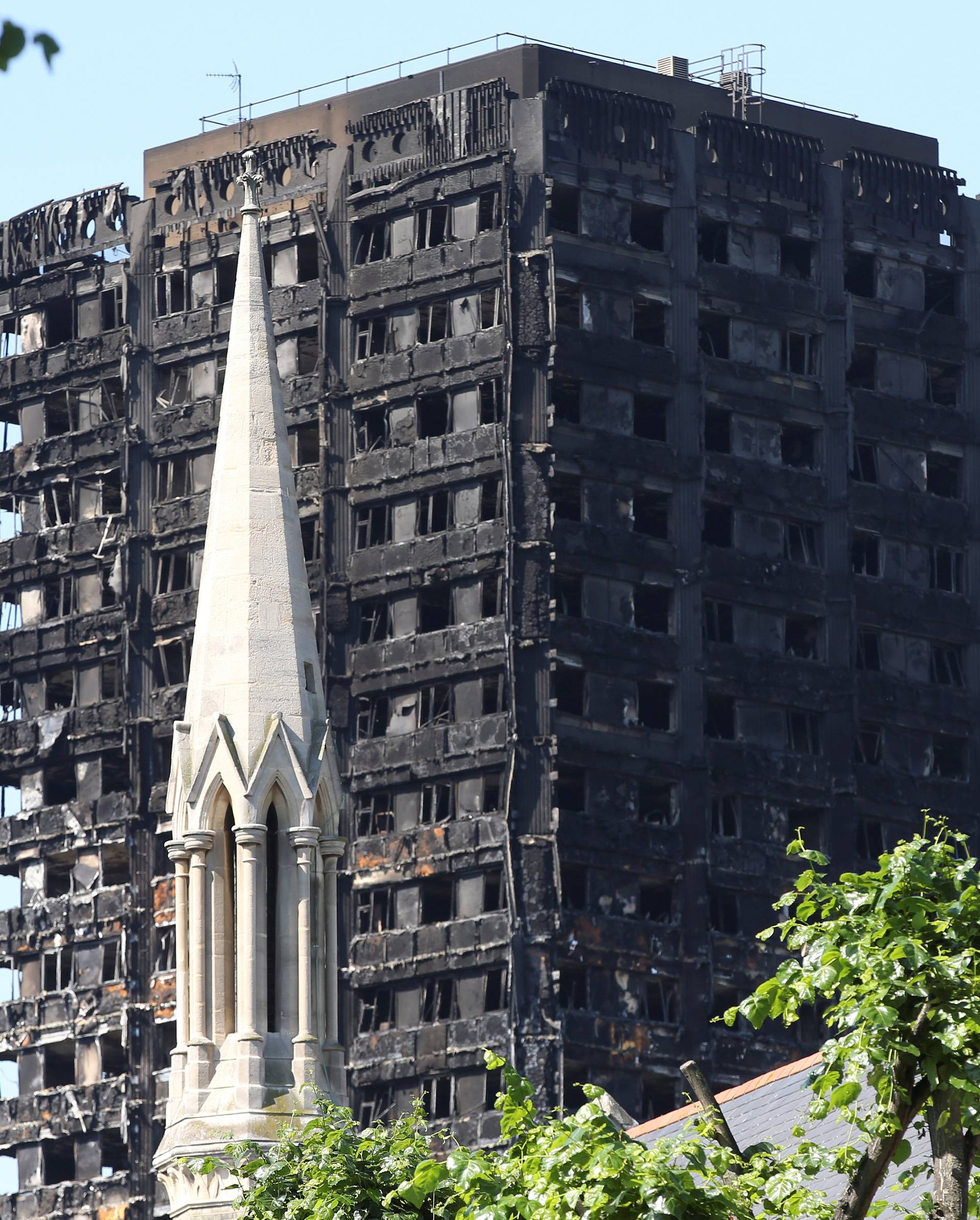 A church spire stands in the foreground of Grenfell Tower in North Kensington, London