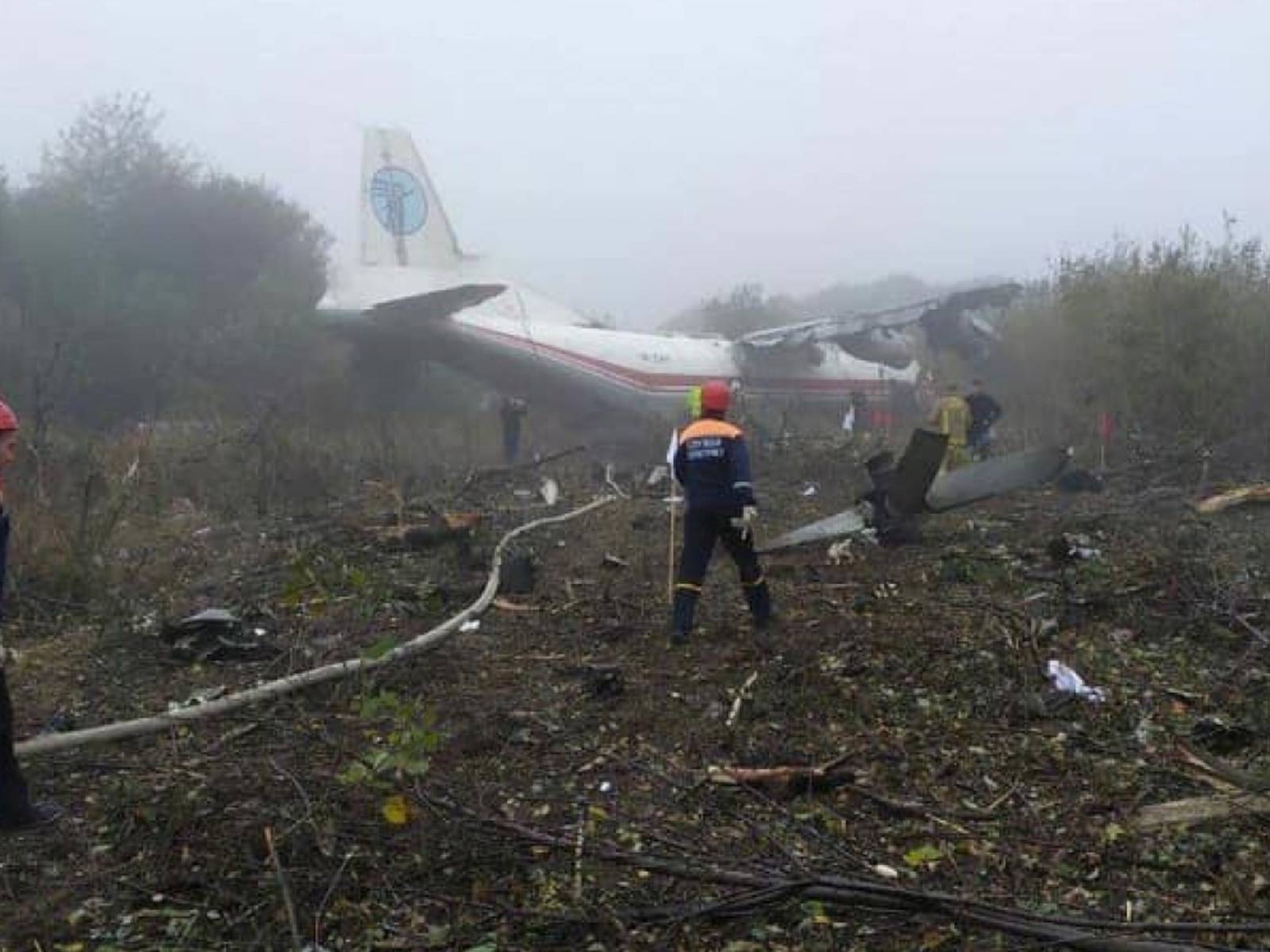 Members of emergency services work at the site of the Antonov-12 cargo airplane emergency landing in Lviv region