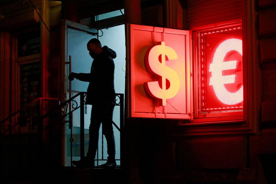 FILE PHOTO: A man walks out of a currency exchange office in Saint Petersburg
