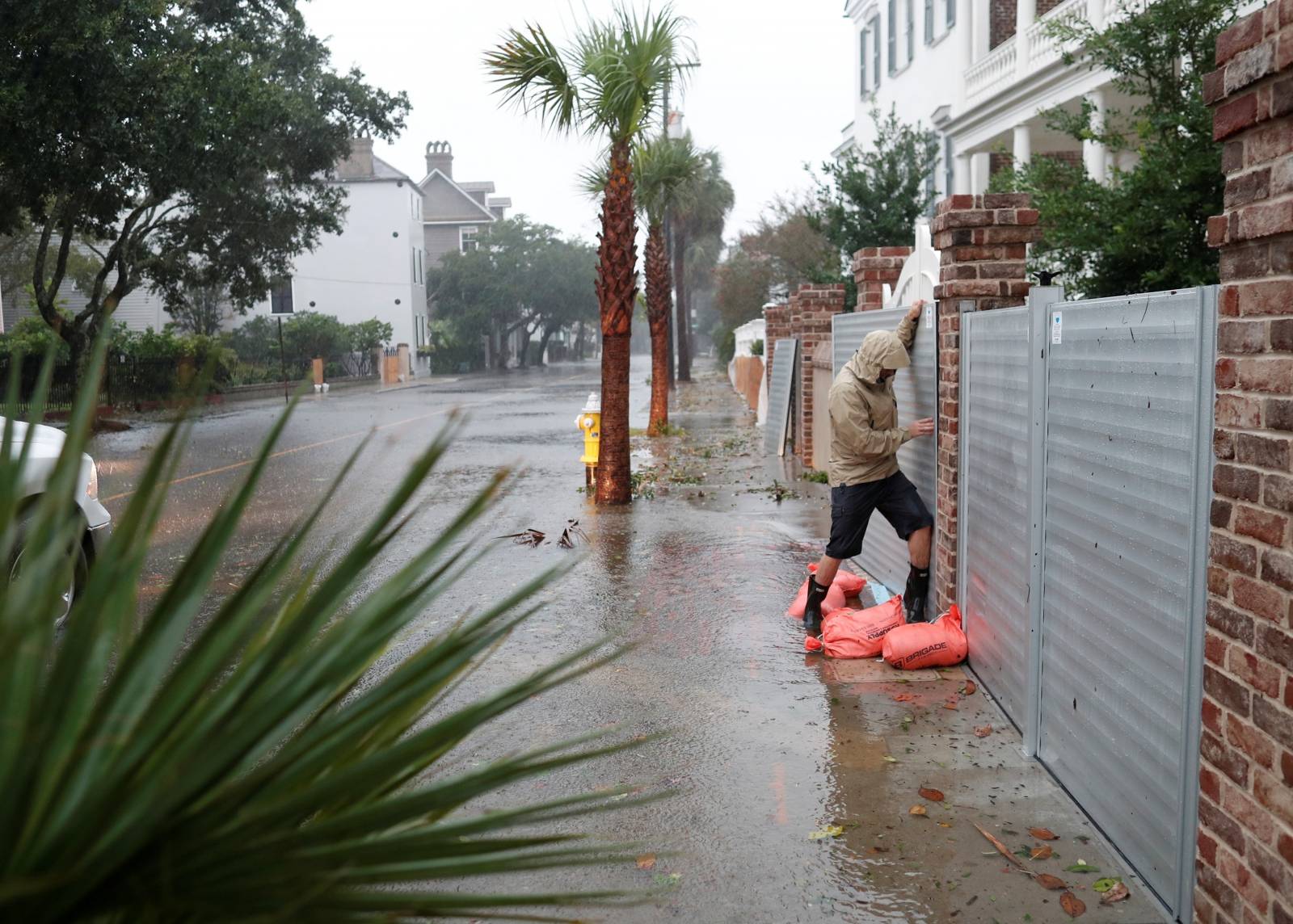 Brys Stephens struggles to install a metal flood gate along South Battery during Hurricane Dorian in Charleston