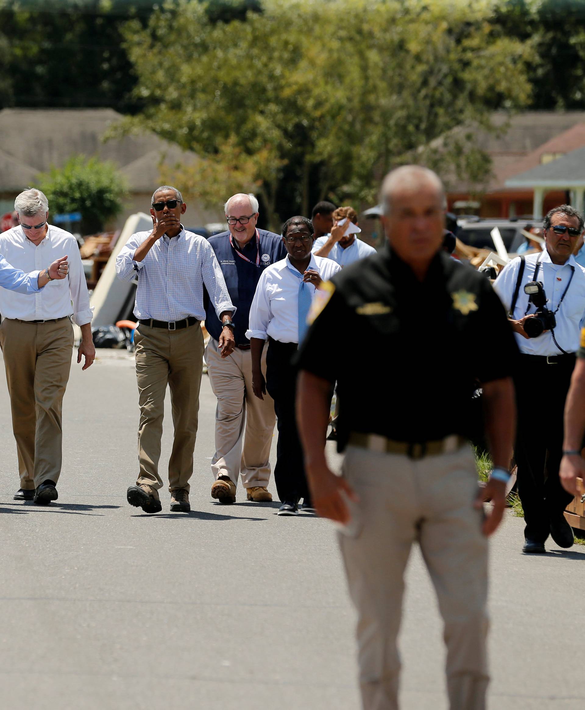 U.S. President Barack Obama tours a flood-affected neighborhood with U.S. Senator David Vitter, Louisiana Governor John Bel Edwards and U.S. Senator Bill Cassidy in Zachary