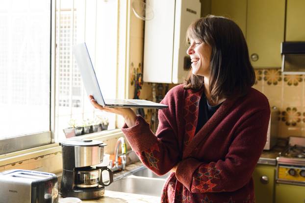An,Adult,Latin,Happy,Woman,Smiling,At,Home,In,A
