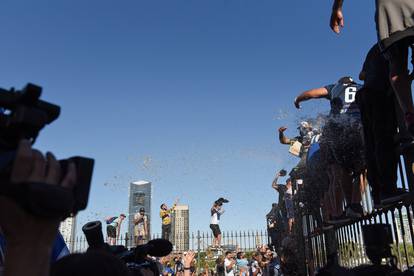 People react as the hearse carrying the casket of soccer legend Diego Maradona leaves the presidential palace Casa Rosada in Buenos Aires