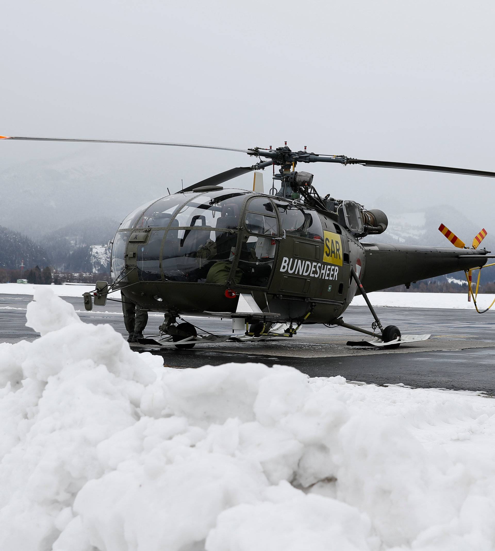 An Austrian army helicopter stands outside a military barrack in Aigen