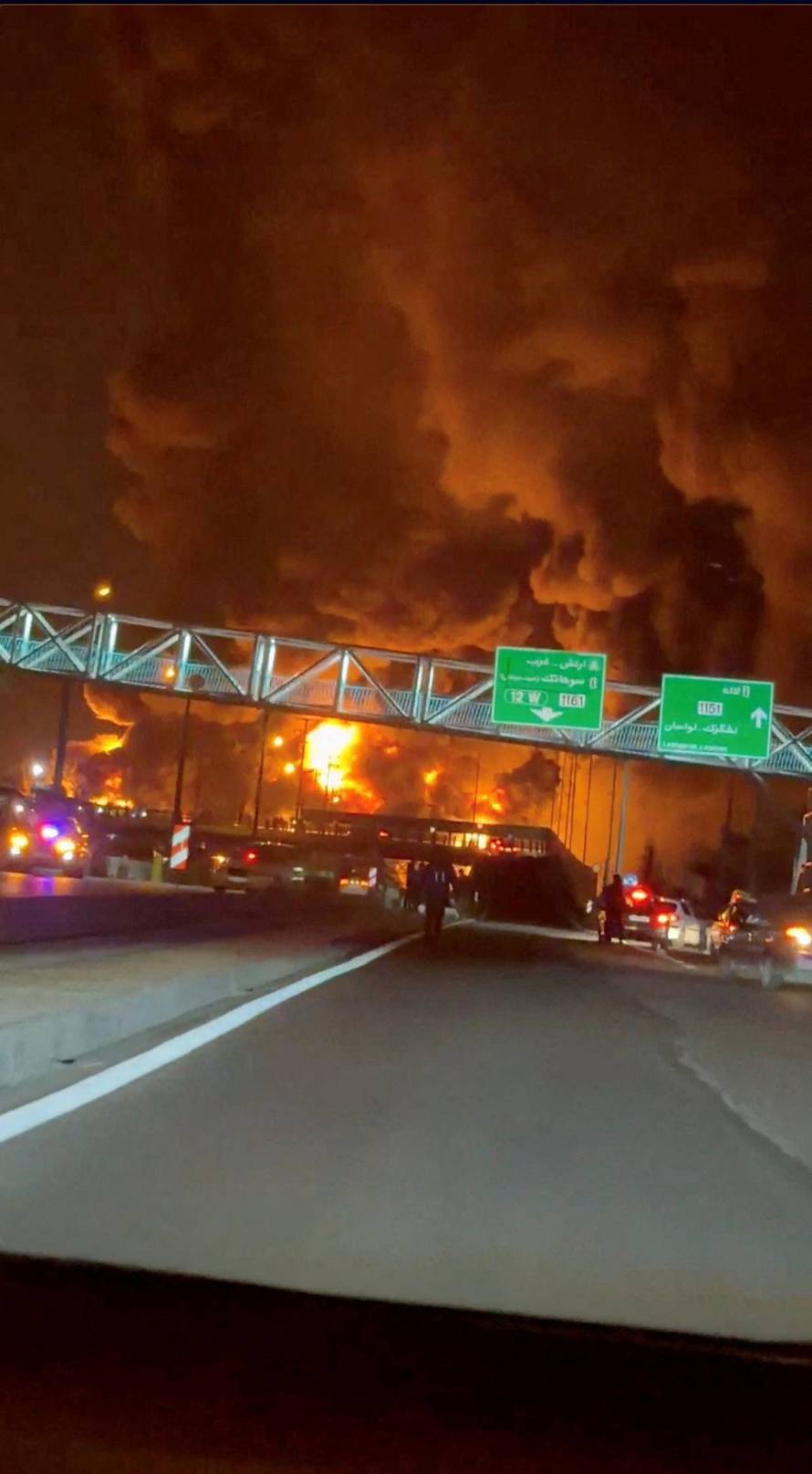 Fire burns and smoke rises from Aqdasieh Oil Depot in Tehran