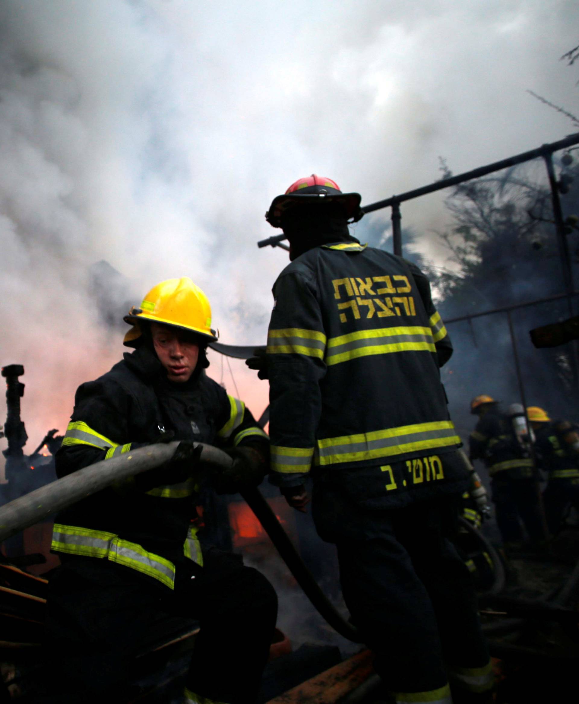 Firefighters work as a wildfire burns in the northern city of Haifa, Israel 