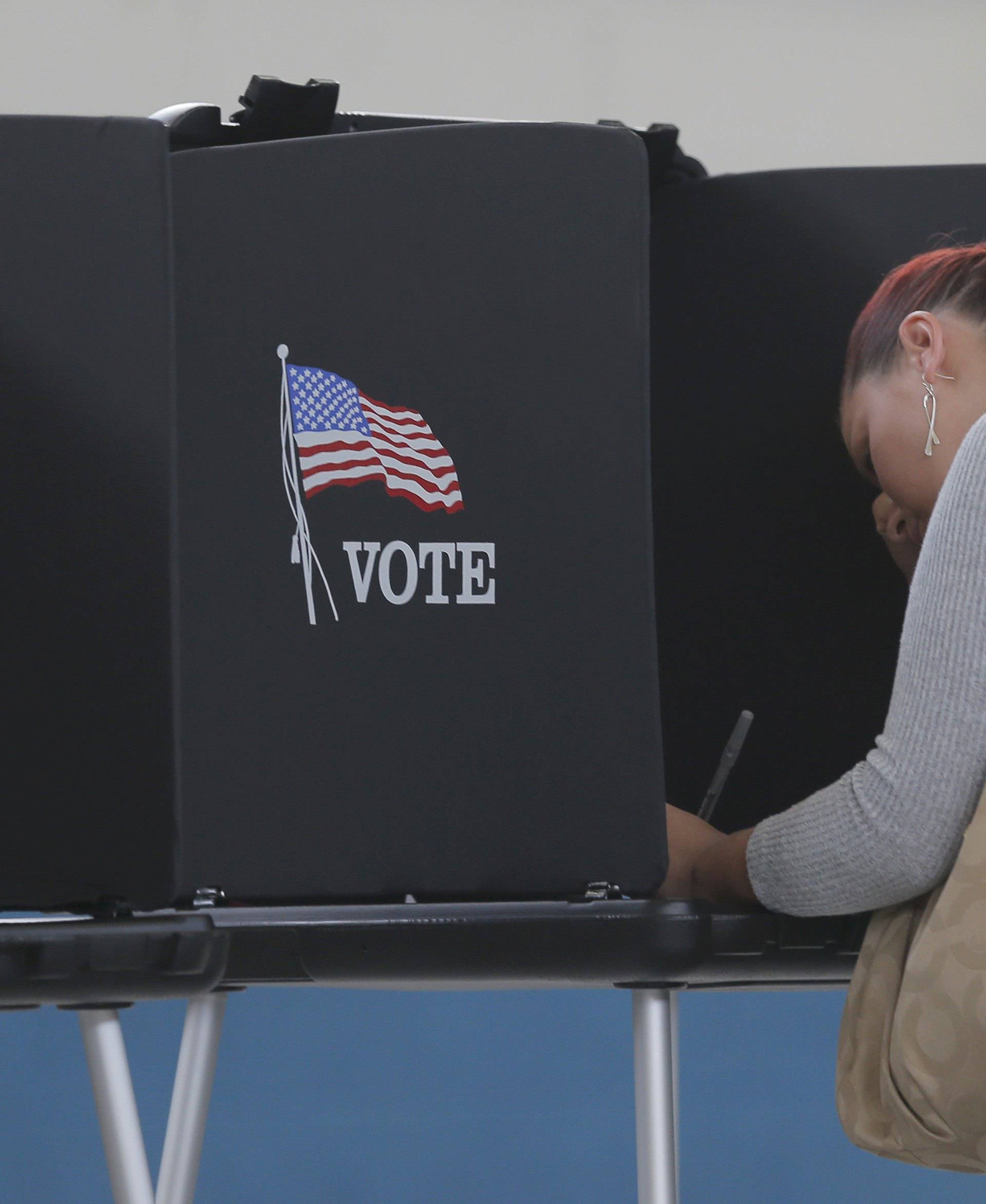 Melissa Foye fills out her ballot as she votes in the U.S. presidential election at the National Guard Armory in Smithfield, North Carolina