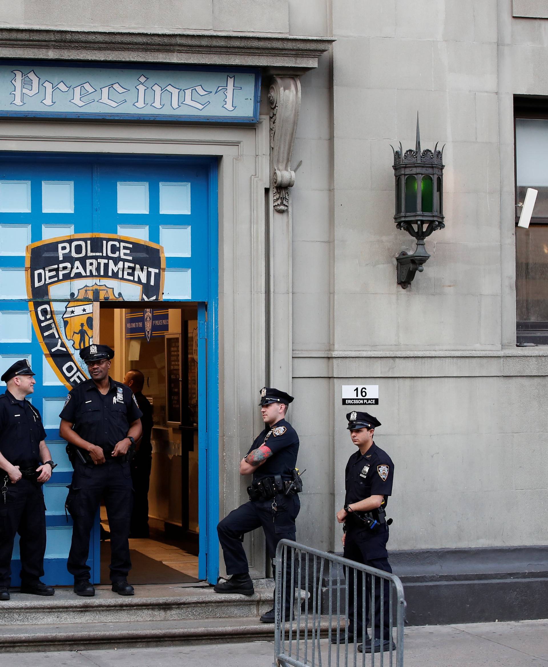 Police officers stand in front of the 1st Precinct in Manhattan as film producer Harvey Weinstein is expected to arrive, in New York