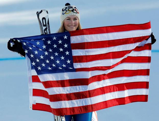 FILE PHOTO: Vonn holds a U.S flag after winning the gold medal in the women's Alpine Skiing Downhill race at the Vancouver 2010 Winter Olympics in Whistler