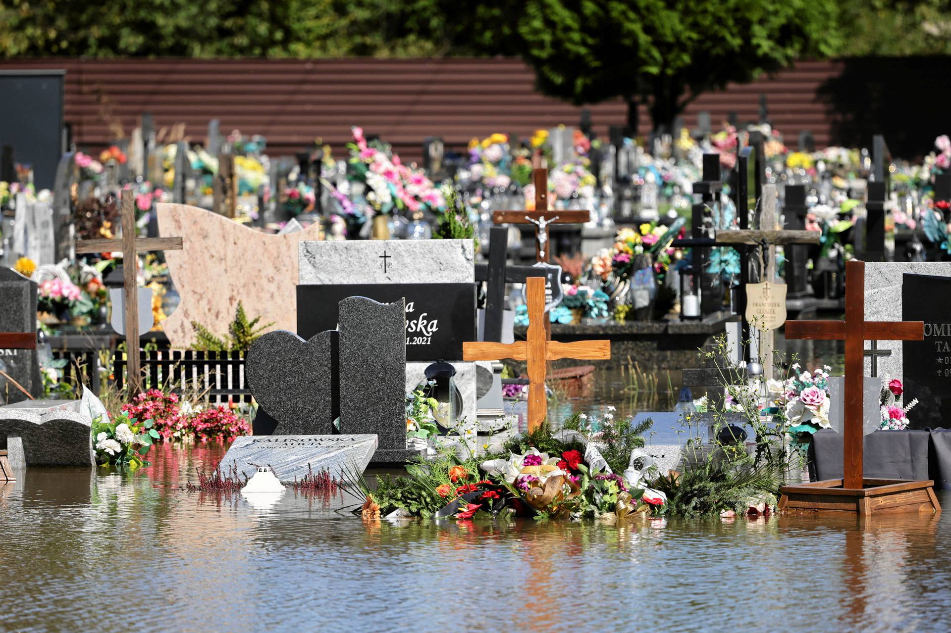 Graves are seen flooded at a cemetery in Brzeszcze, Lesser Poland region