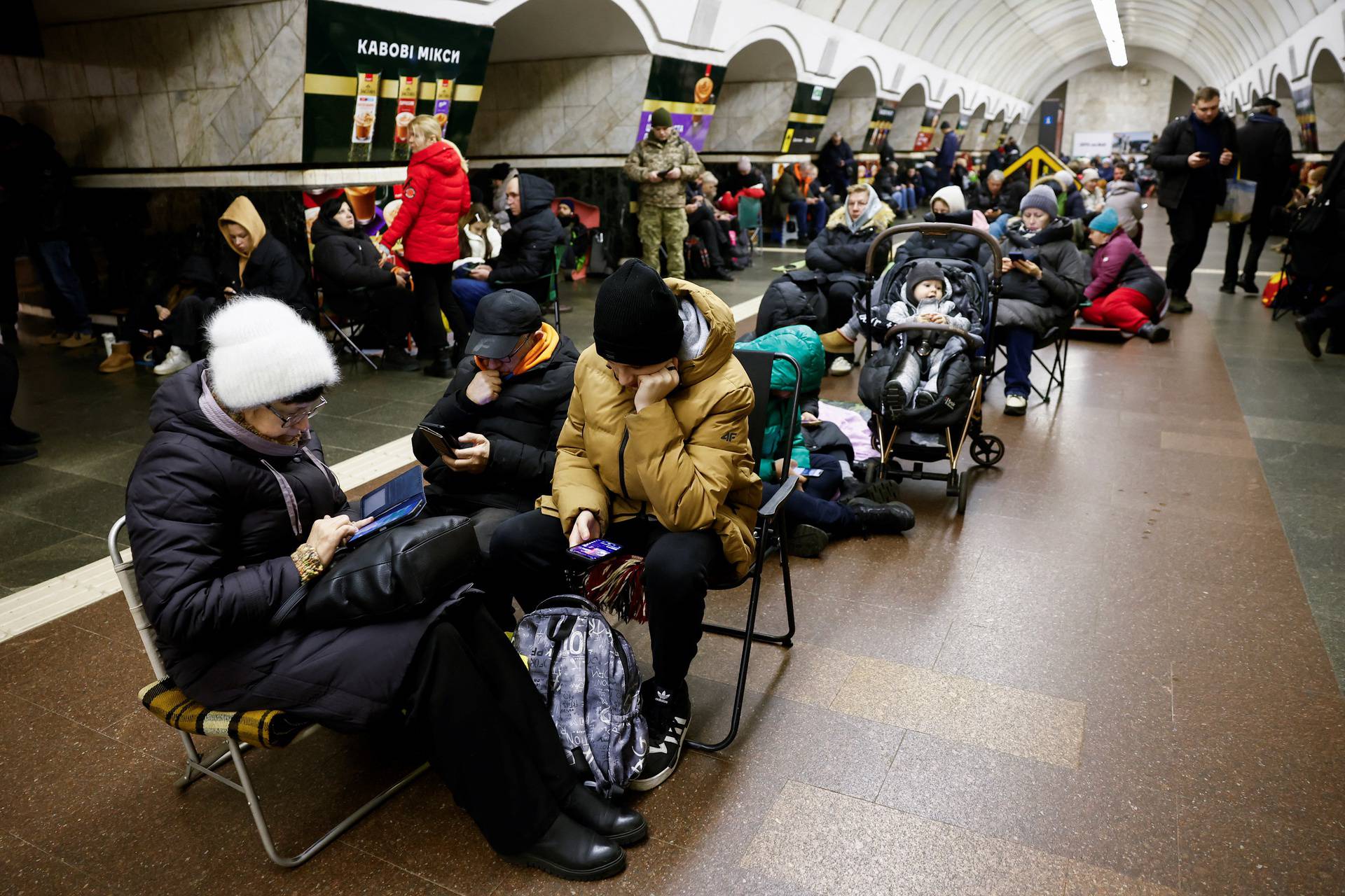 People take shelter at a metro station during an air raid alert, in Kyiv