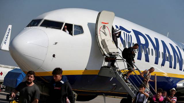 FILE PHOTO: Passengers alight from a Ryanair aircraft at Ferenc Liszt International Airport in Budapest