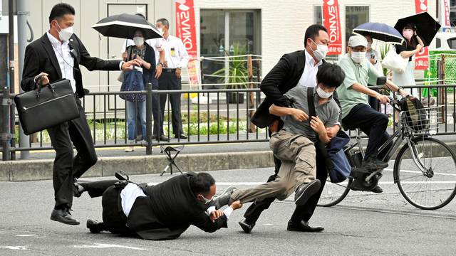 A man, believed to have shot former Japanese Prime Minister Shinzo Abe, is tackled by police officers in Nara, western Japan