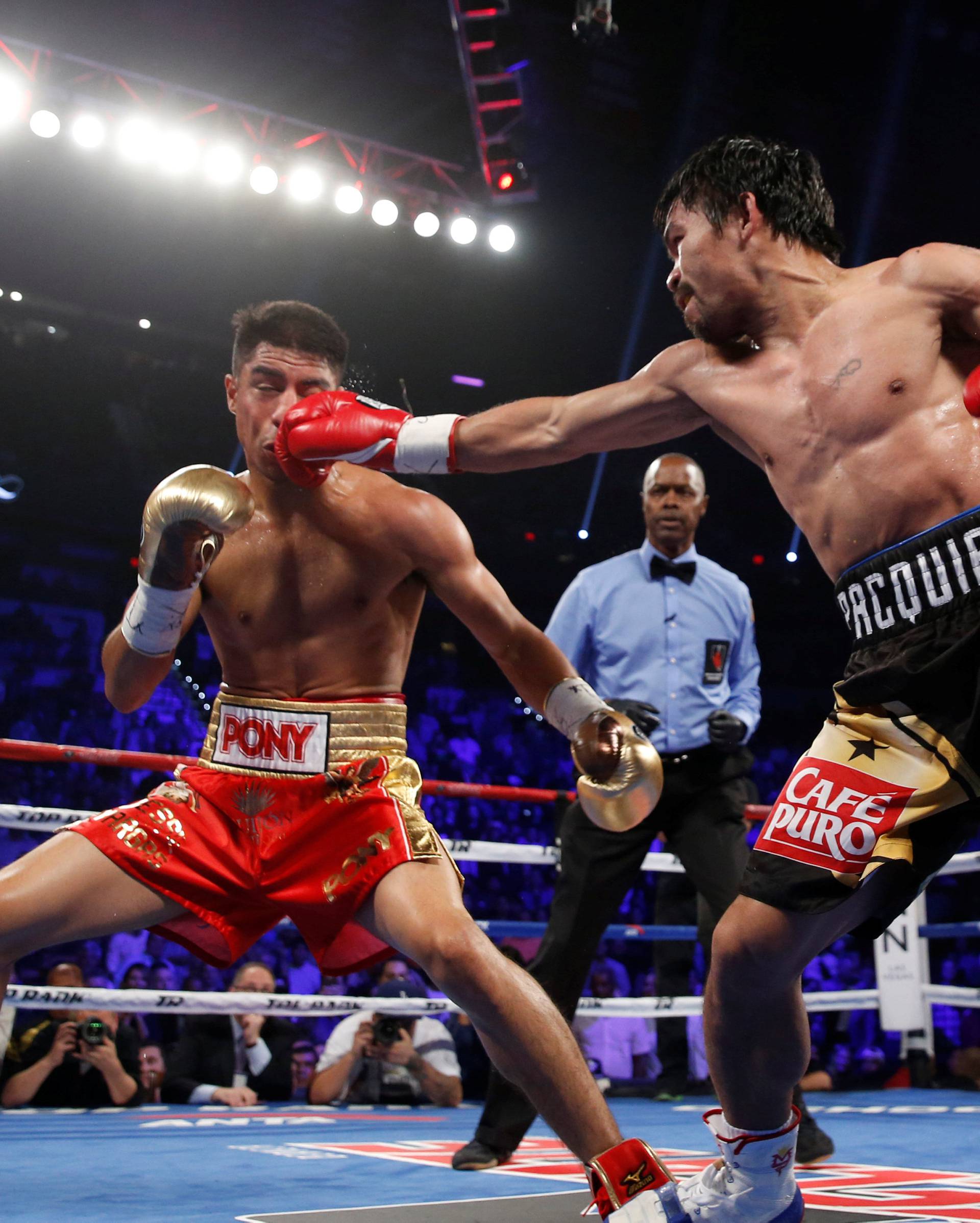 Manny Pacquiao (R) of the Philippines connects with a jab on WBO welterweight champion Jessie Vargas of Las Vegas during their title fight at the Thomas & Mack Center in Las Vegas