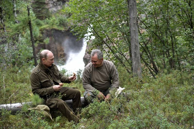 Russian President Vladimir Putin and Defence Minister Sergei Shoigu rest during the hunting and fishing trip which took place on August 1-3 in the republic of Tyva in southern Siberia